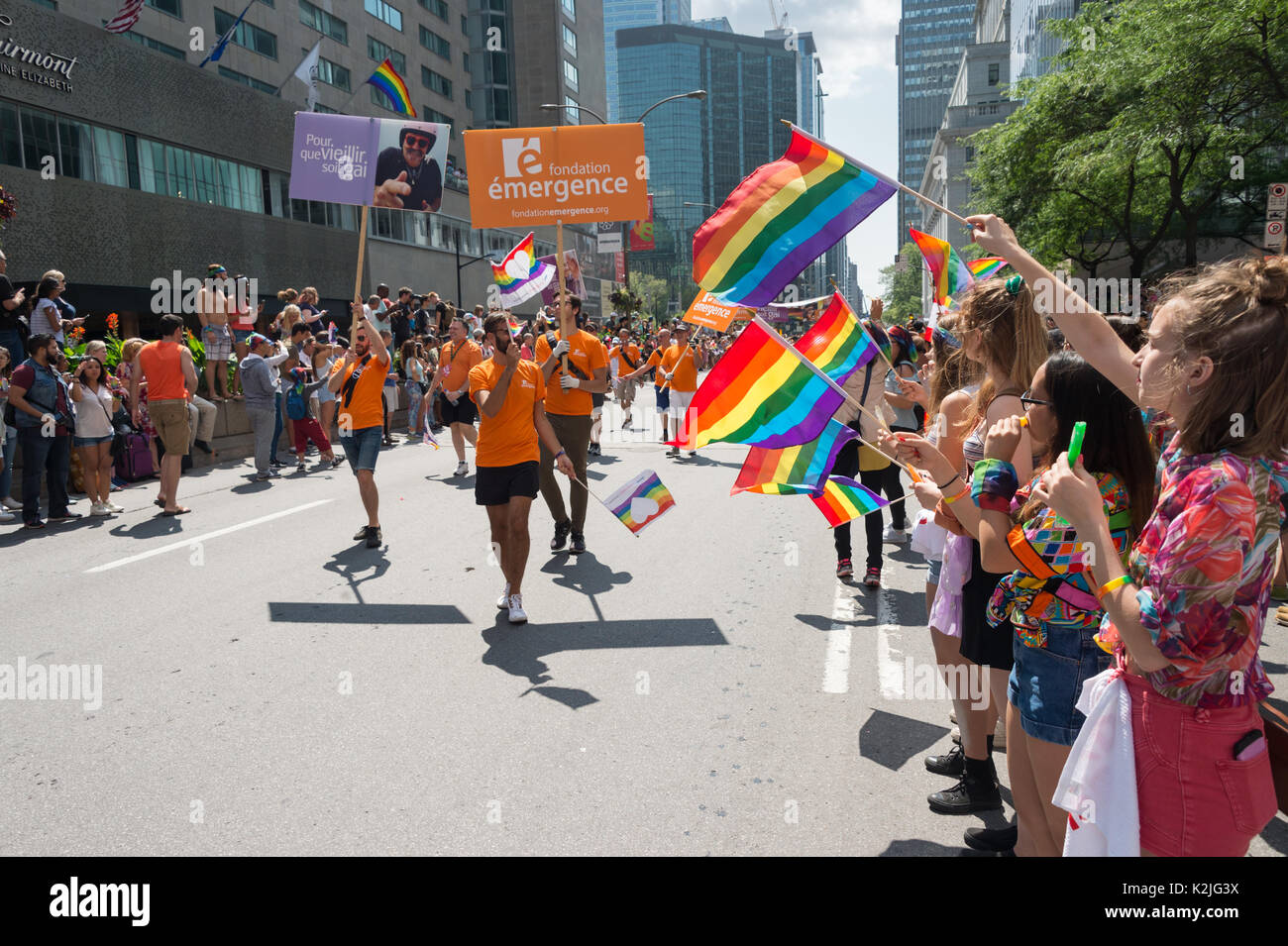 Montréal, le 20 août 2017 : spectateurs holding gay rainbow flags à la parade de la fierté gaie de Montréal Banque D'Images
