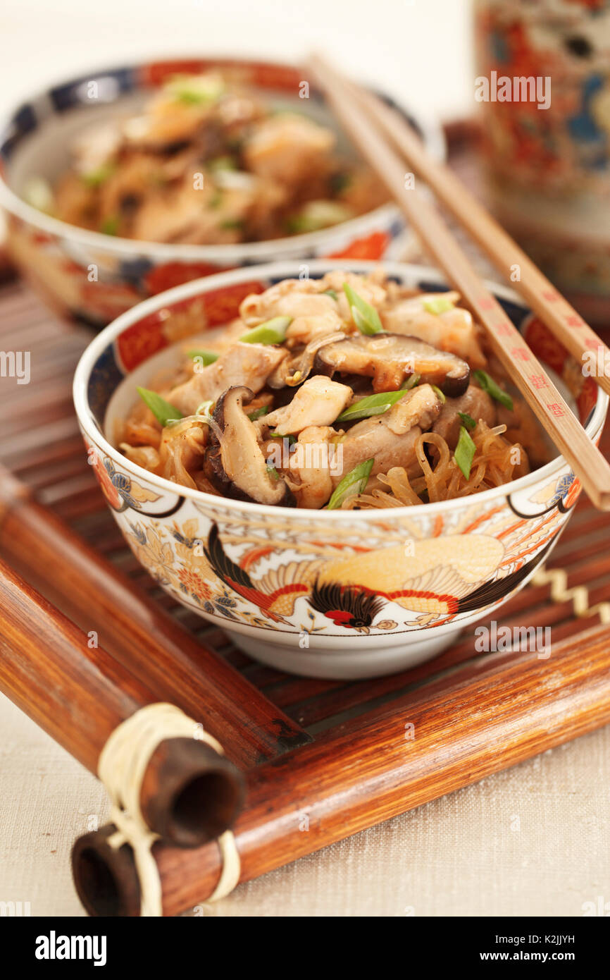 Poulet avec des nouilles asiatiques et les champignons shiitake Banque D'Images