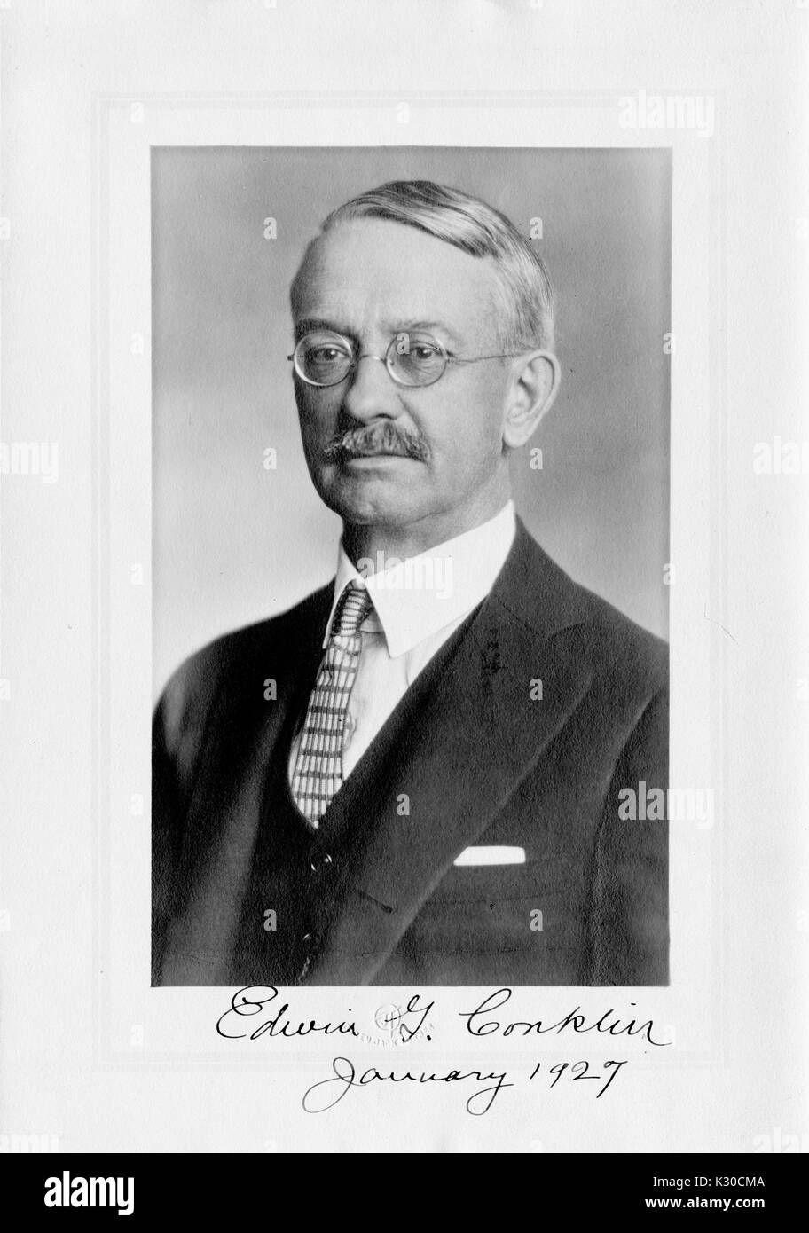 Portrait, la poitrine vers le haut, de Edwin Grant Conklin, zoologiste et biologiste à l'Université Johns Hopkins, souriant avec des lunettes, avec nom et date, Baltimore, Maryland, 1927. Banque D'Images