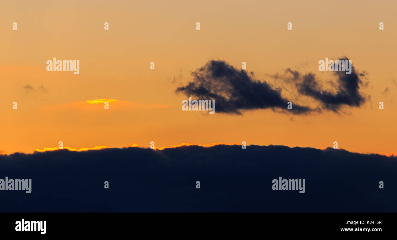 Les nuages colorés pendant le coucher du soleil plus de Frise orientale Banque D'Images