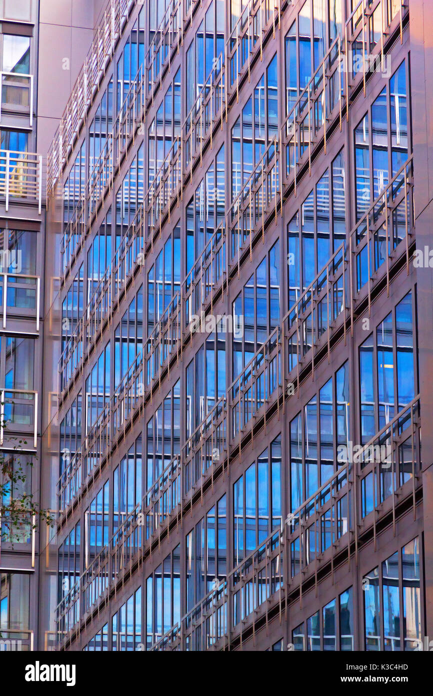 L'architecture contemporaine moderne contexte : de l'extérieur d'un immeuble de bureaux moderne, façade futuriste avec des reflets de couleur bleu de lumière w verre Banque D'Images