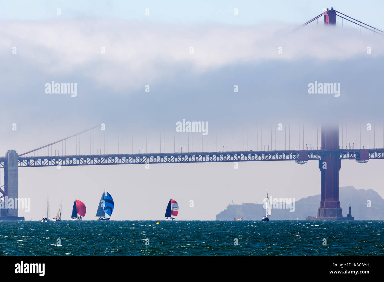 Trois spinnakers plus lieu que le vent porte les voiliers retour sous le Golden Gate Bridge Banque D'Images