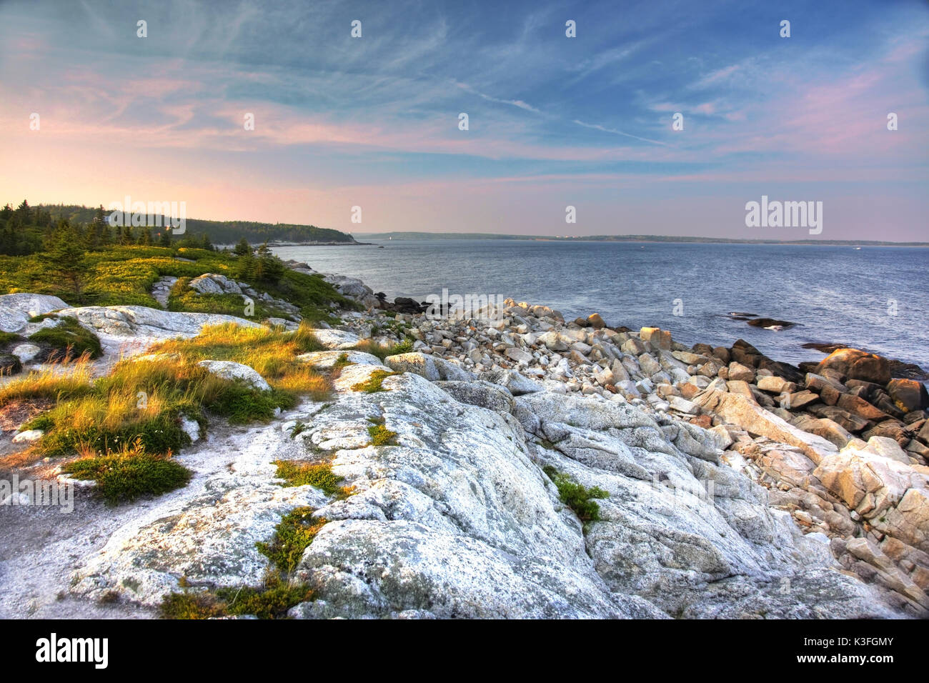 Ciel bleu et rose sur l'océan avec des roches blanches Banque D'Images