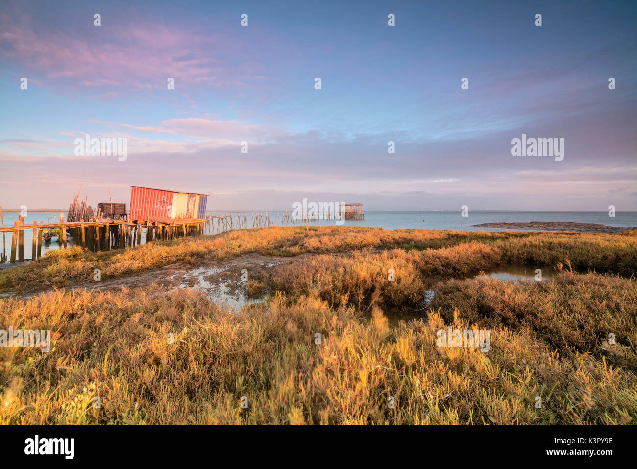 Ciel rose à l'aube sur la jetée dans la maison sur pilotis Carrasqueira Réserve naturelle du fleuve Sado Alcacer do Sal Setubal Portugal Europe Banque D'Images
