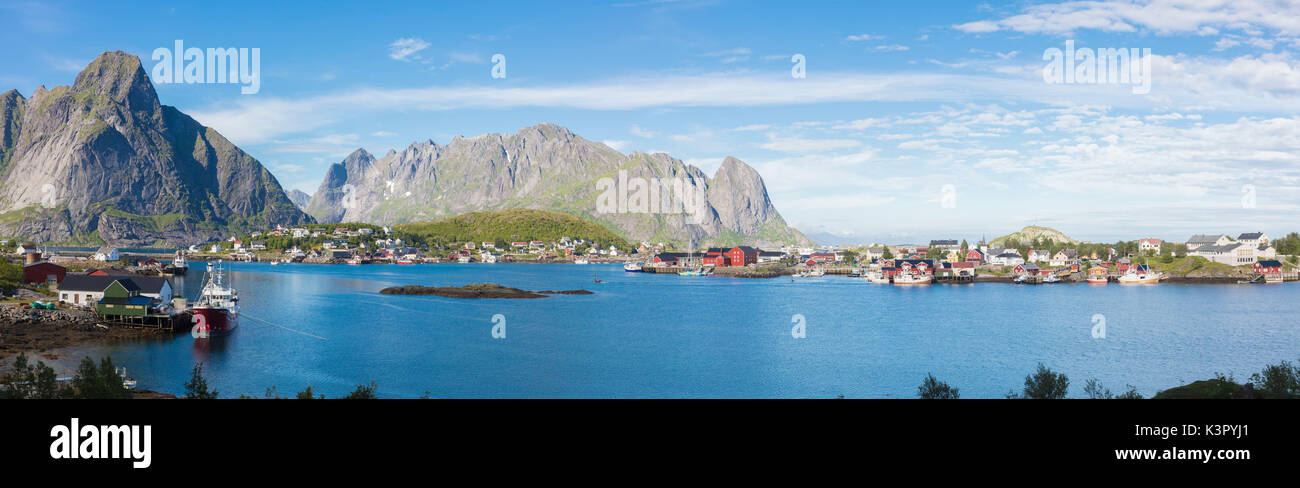 Panorama de la mer bleue entourant le village de pêcheurs et pics rocheux Reine Norvège Iles Lofoten Moskenes Europe Banque D'Images