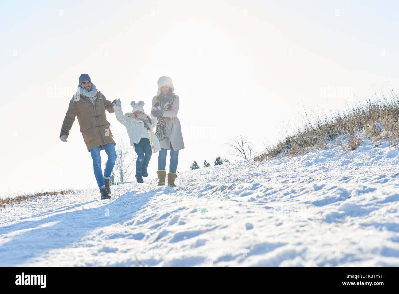 Happy Family fait une promenade dans la neige en hiver Banque D'Images