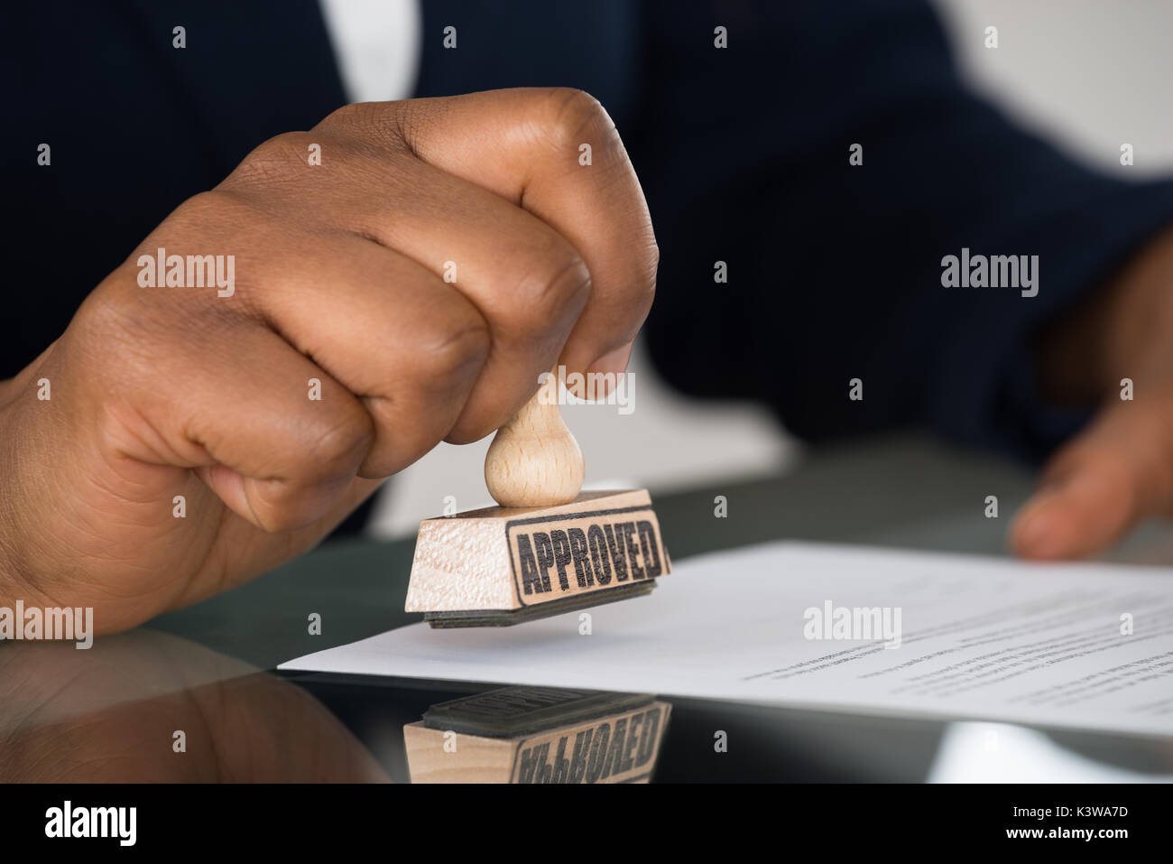 Close-up of a person's Hand piétinement sur le formulaire de contrat approuvé Banque D'Images
