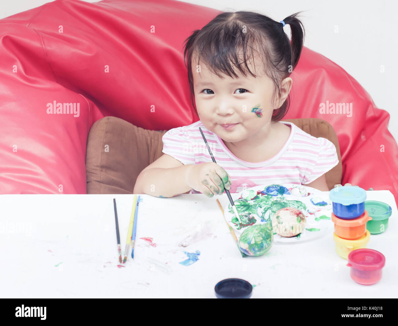 Petite fille la peinture avec le pinceau et les peintures colorées de ce concept de développement des enfants Banque D'Images