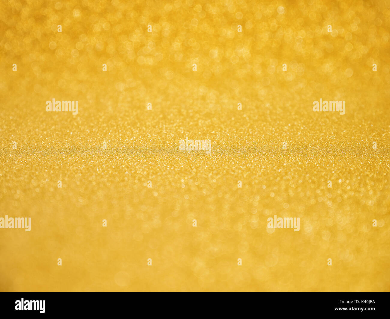 Gold Glitter Background pour célébrer Noël fond rougeoyant Banque D'Images