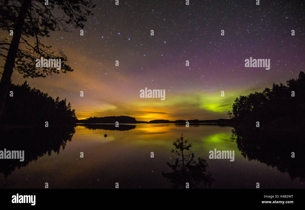 Aurora avec beaucoup d'Étoiles avec reflet dans le lac finlandais Banque D'Images