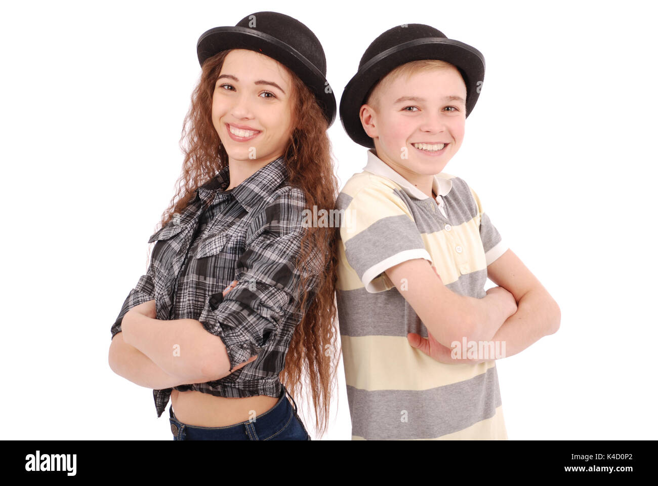 Portrait of young girl and boy posing in black bowler hat isolated on white Banque D'Images