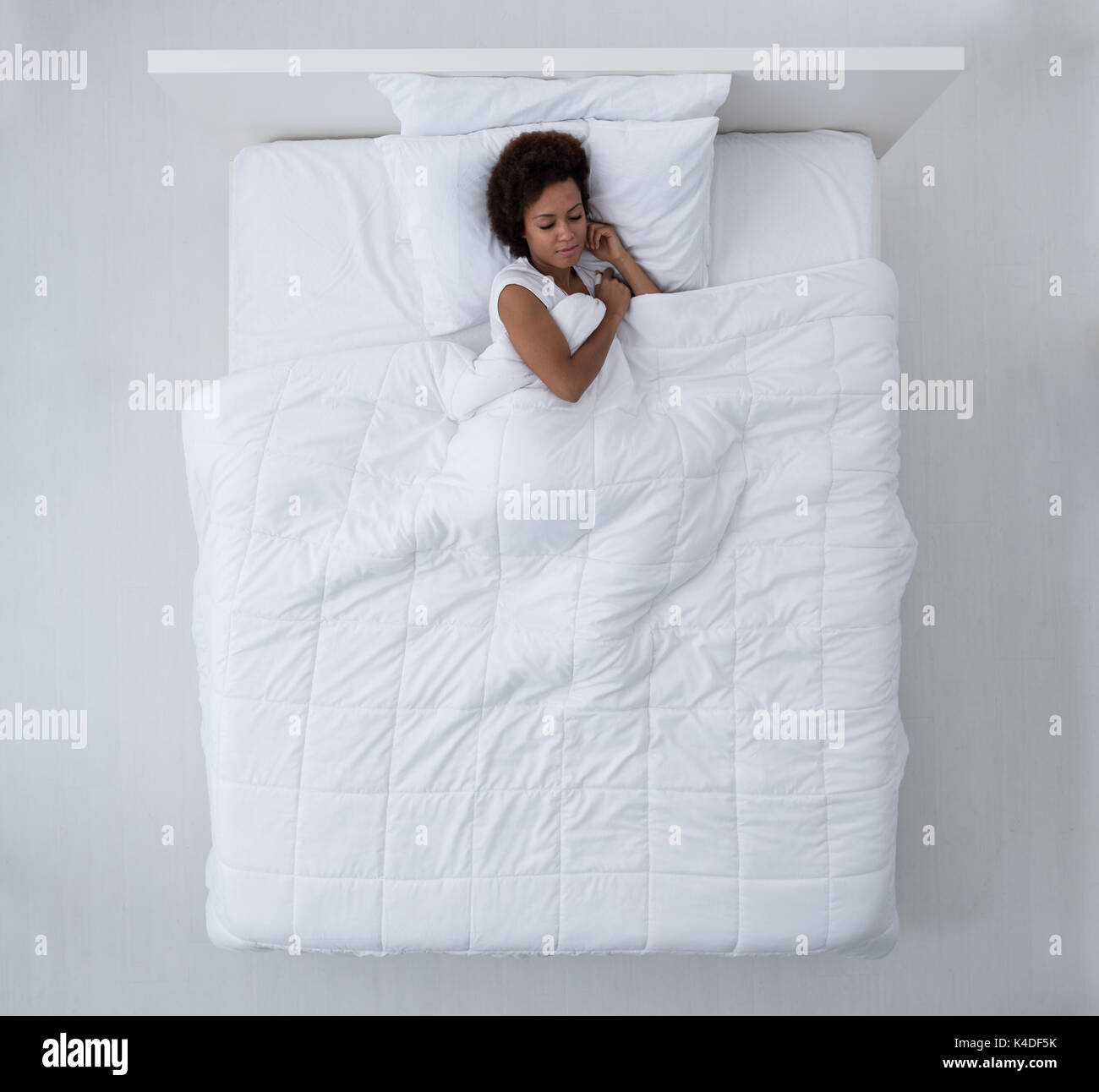 Belle african american woman au lit et dormir, vue du dessus Banque D'Images