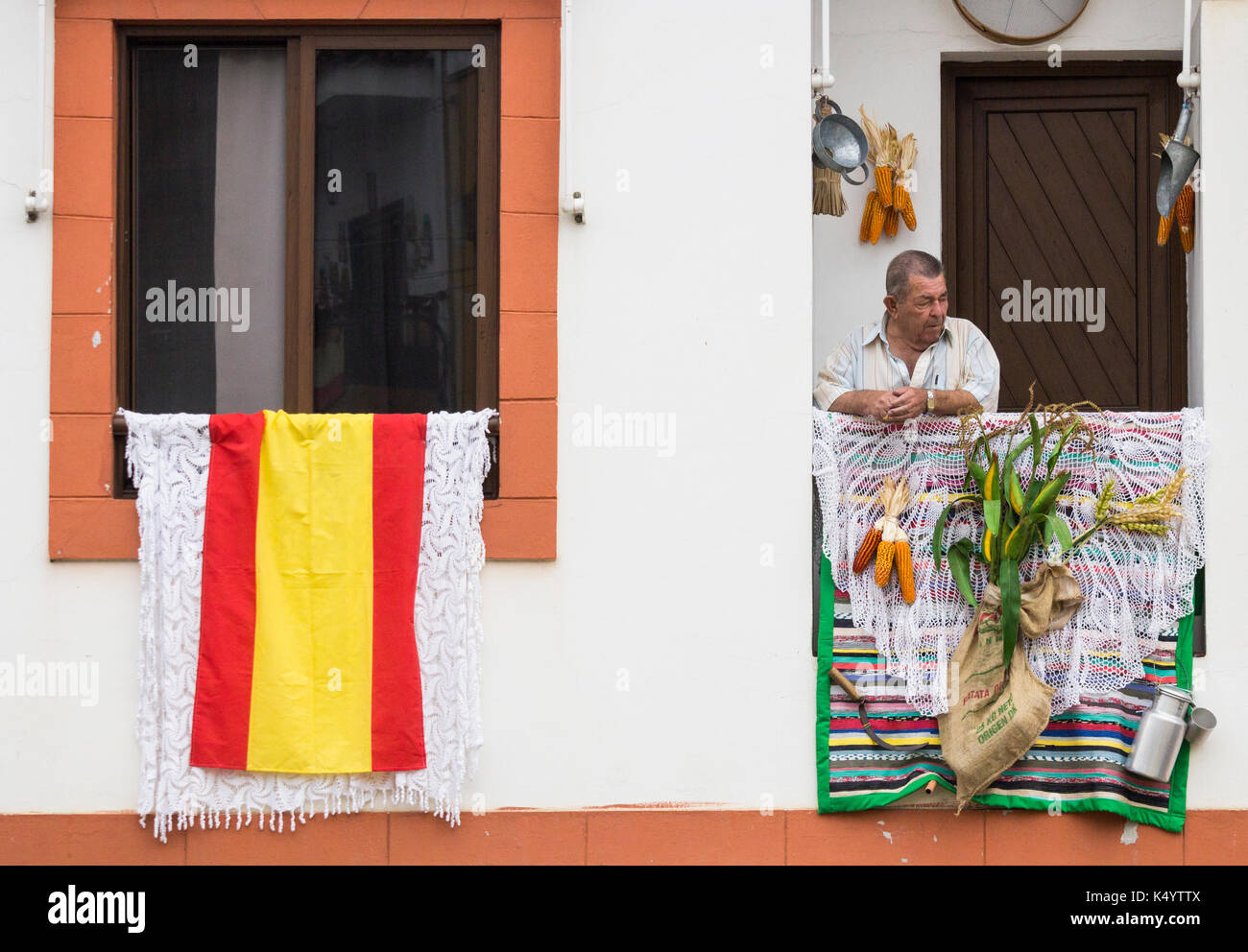 Teror, Gran Canaria, îles canaries, espagne. 30Th jun 2017. chaque année le 7/8th sept, des milliers de pèlerins (peregrinos) font leur chemin vers le village de montagne de teror sur Gran Canaria pour rendre hommage au saint patron de l'île, Nuestra Senora del pino. photo : un homme regarde la Street Parade à partir de son balcon. crédit : Alan dawson/Alamy live news Banque D'Images