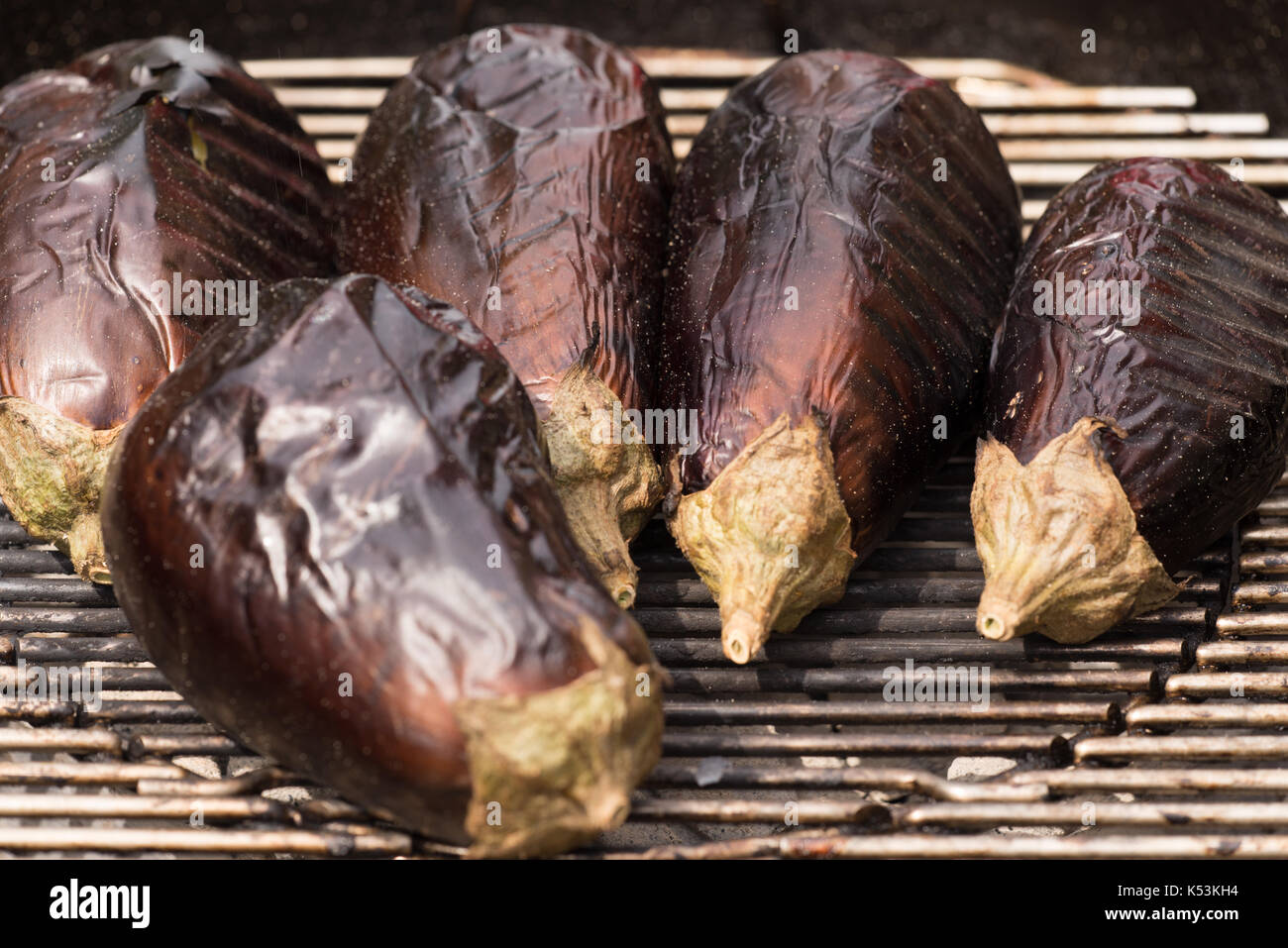 Aubergines grillées sur feu de charbon en préparation d'une salade d'aubergine. Banque D'Images