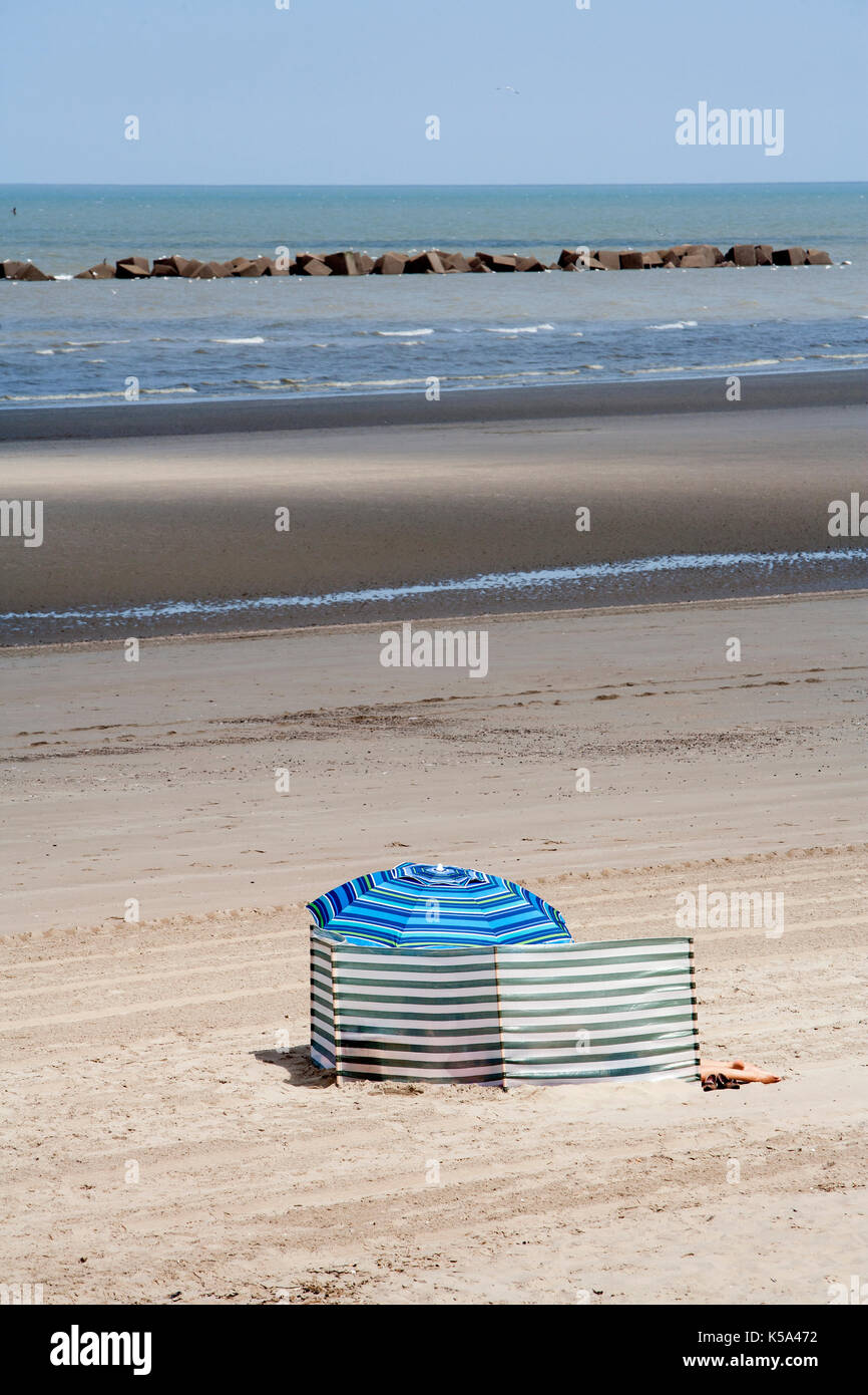 Seul et bien protégé contre le soleil et le vent sur une plage dans le Nord de la France Banque D'Images