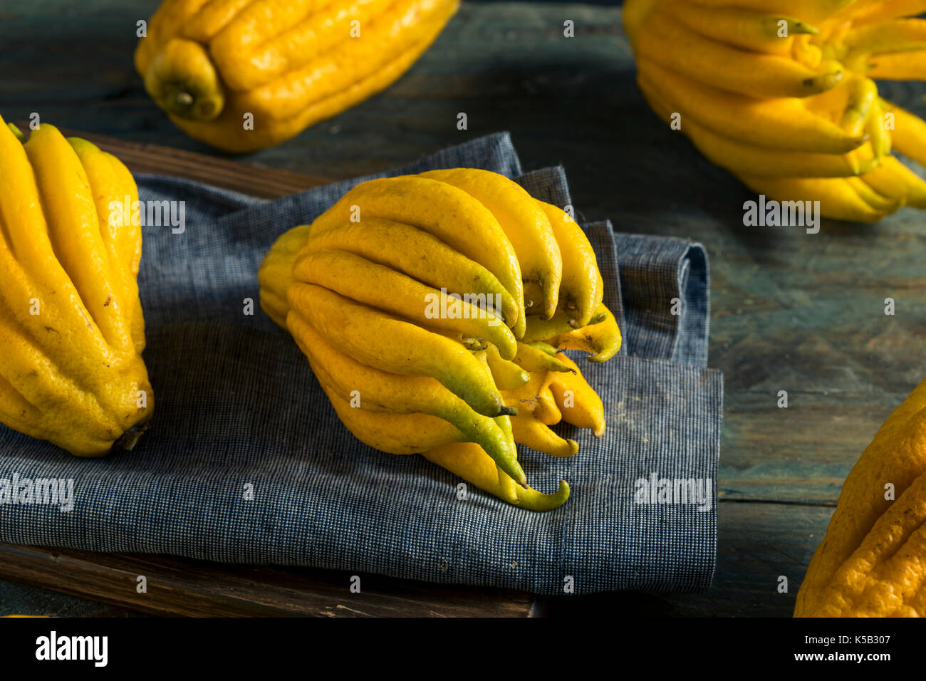 Bouddhas organique jaune part d'agrumes avec les doigts Banque D'Images