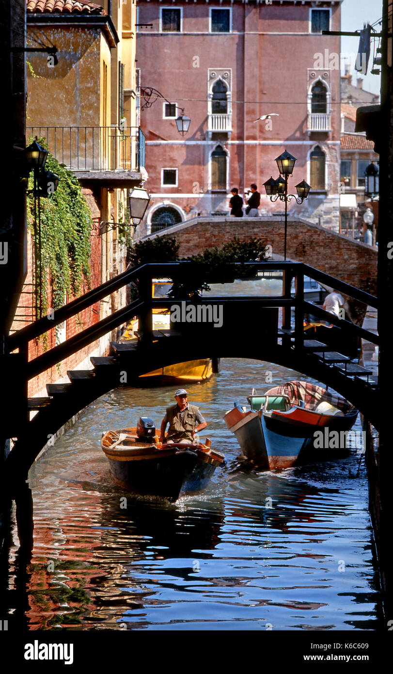 Venise, Vénétie, Italie. Scène du canal à l'aide de ponts et de petits bateaux privés Banque D'Images