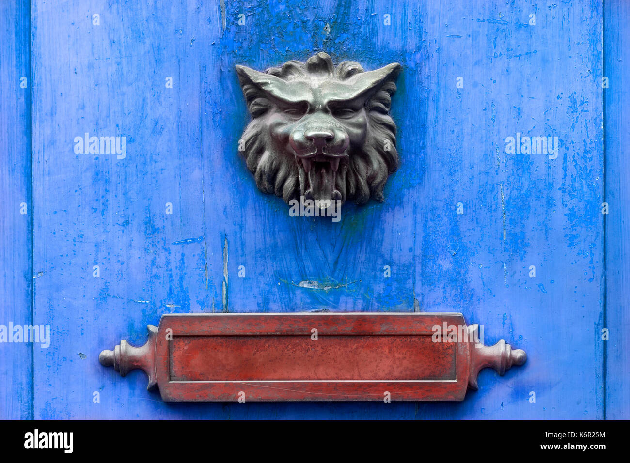 Doorknocker métal rouge et lettre fort sur une porte en bois bleu Banque D'Images