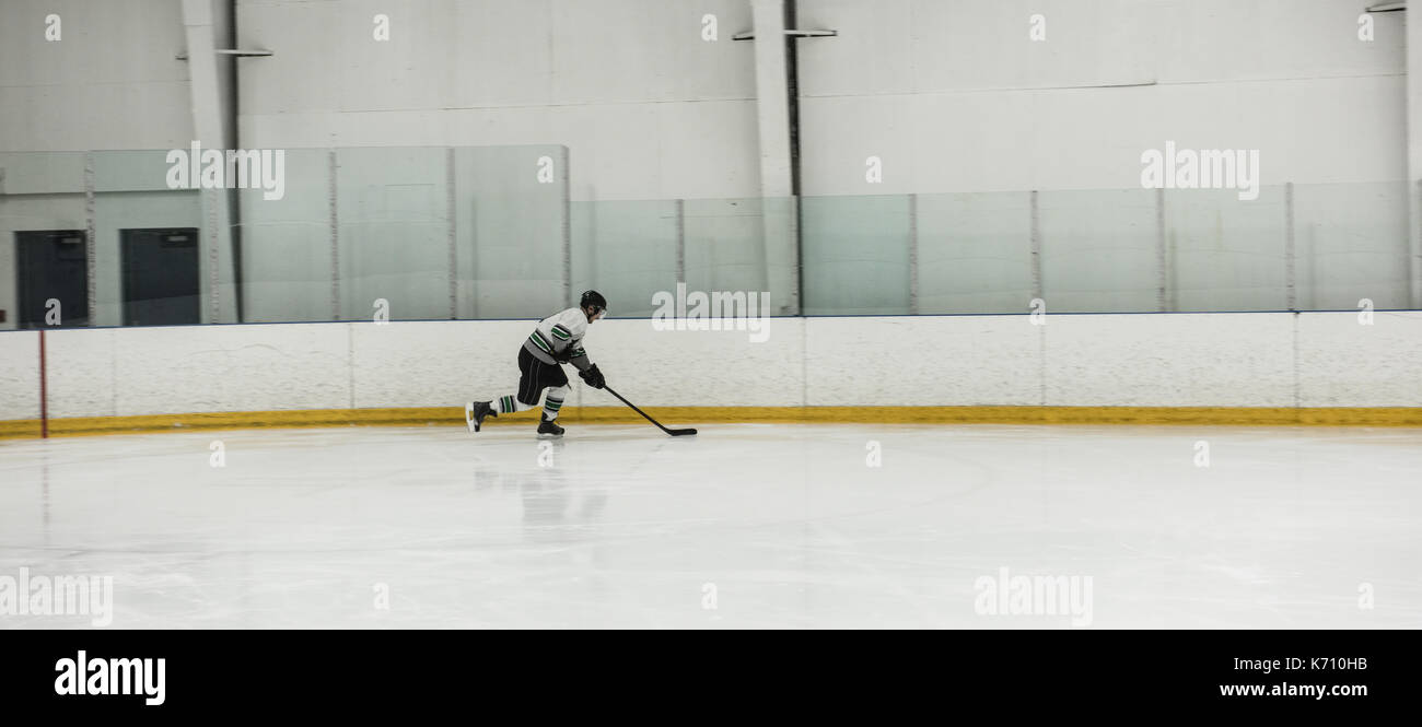 Joueur de hockey sur glace masculin pratiquant au rink Banque D'Images
