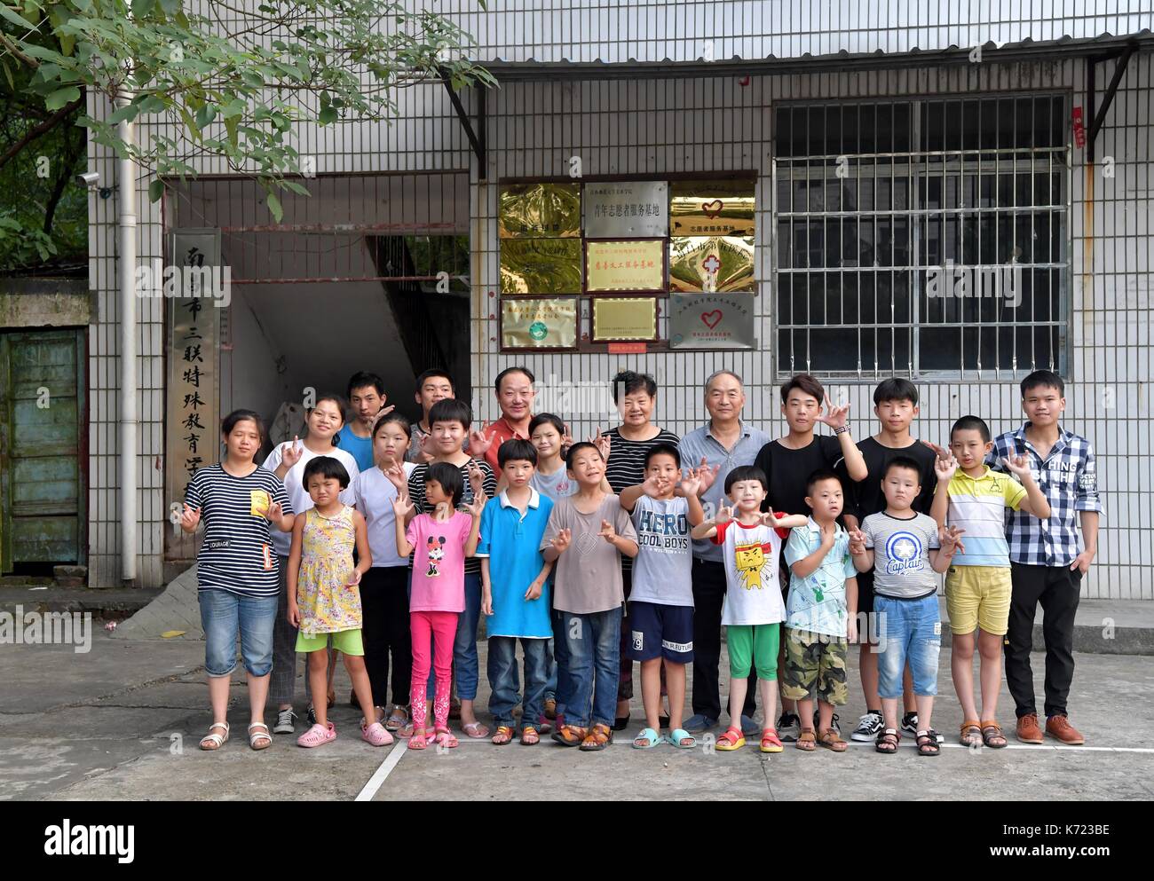 (170914) -- nanchang, sept. 14, 2017 (Xinhua) -- il xingwu pose pour une photo de groupe avec ses élèves à une école spéciale à Nanchang, province de Jiangxi en Chine de l'Est, sept. 13, 2017. Les 74 ans, enseignant, il xingwu a travaillé dans l'école spéciale depuis 23 ans. Il a perdu l'audition à l'âge de huit ans en raison de l'utilisation inappropriée de médicaments. En 1994, lui et son ami a fondé l'école après sa retraite. plus de 300 à l'audition et des malentendants francophones les étudiants ont obtenu un diplôme de l'école. (Xinhua/peng zhaozhi) (zkr)(zt) Banque D'Images