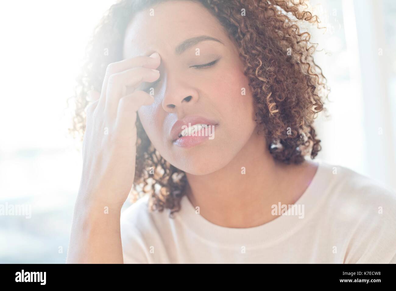 Mid adult woman touching her face. Banque D'Images