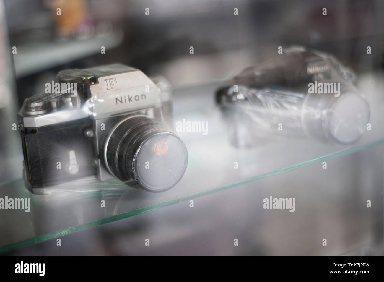 Appareils photo Nikon sous film rétractable vintage sur une étagère Banque D'Images