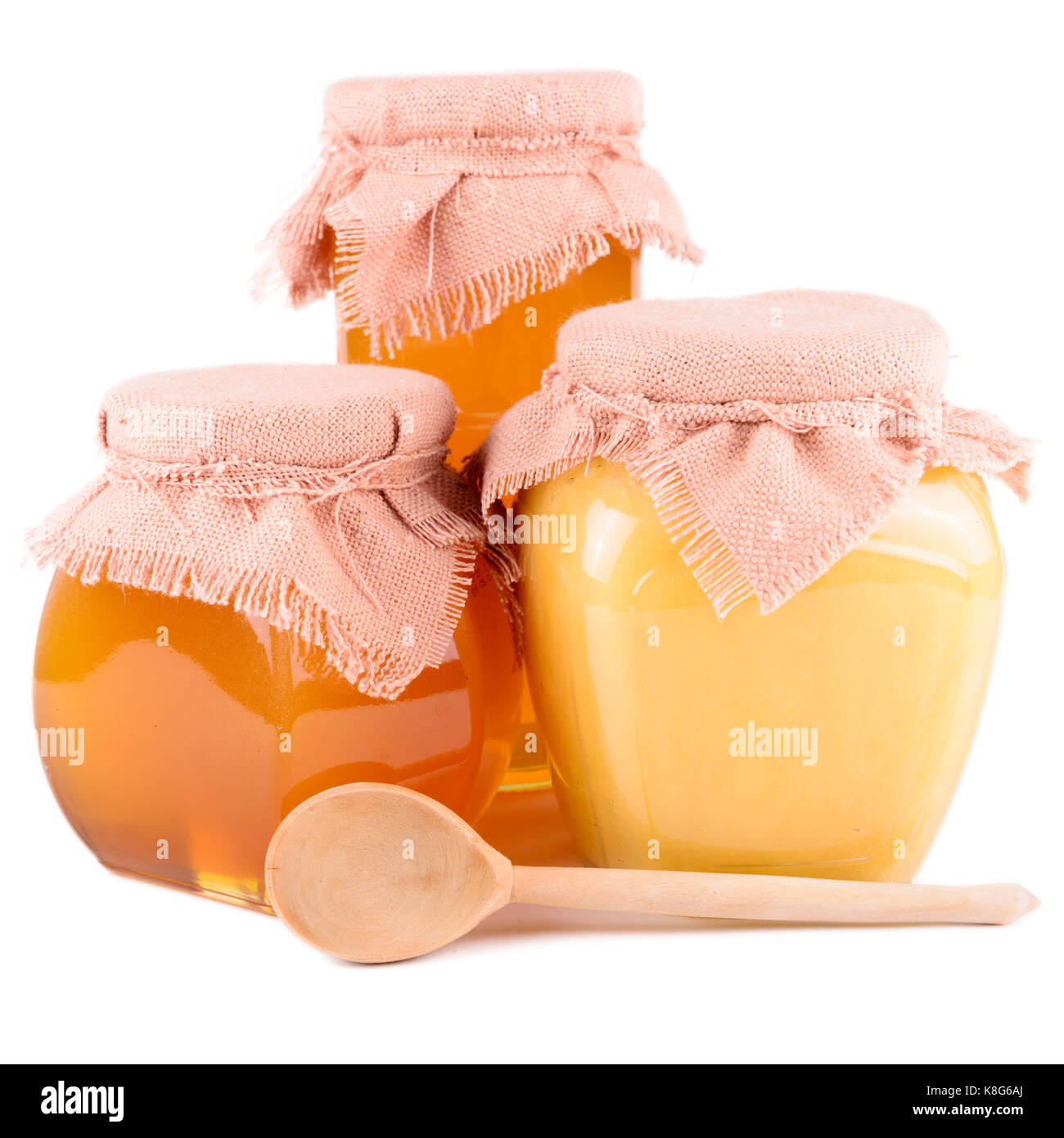 Plusieurs pots de miel sur un fond blanc Banque D'Images