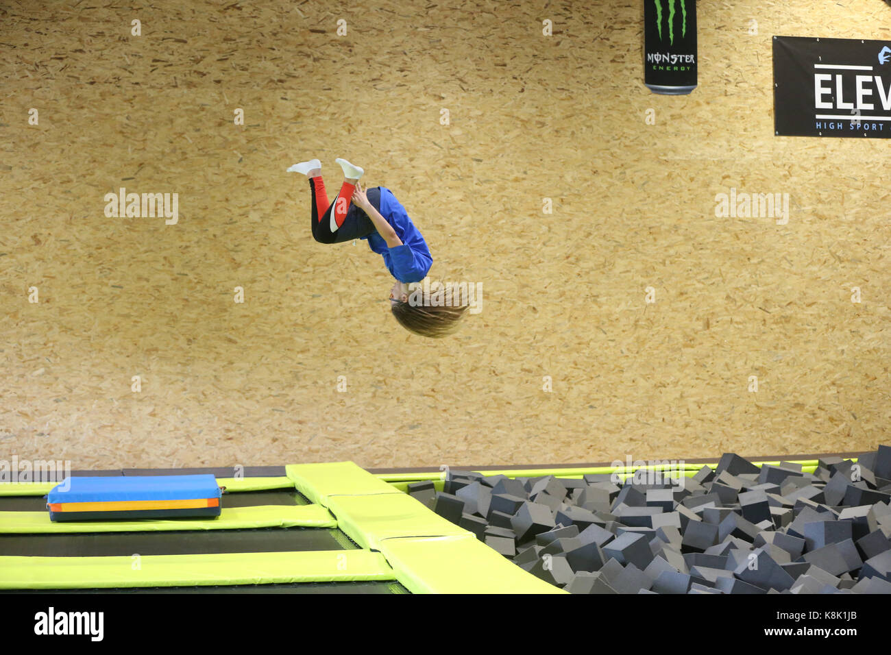 Girl jumping on trampoline. France. Banque D'Images