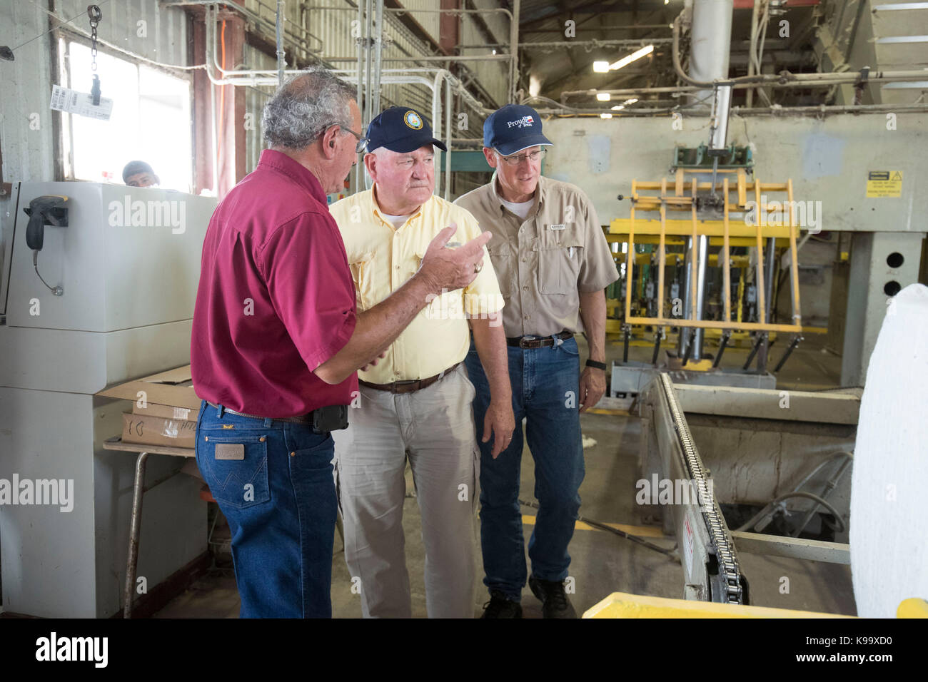 El Campo, États-Unis. 21 septembre 2017. Le secrétaire américain à l'Agriculture Sonny Perdue (chemise jaune) et le président de la Maison de l'Agriculture Mike Conaway (Tan) ont fait une tournée de gin de coton après avoir rencontré des agriculteurs dont les cultures de coton ont été ravagées par l'ouragan Harvey il y a trois semaines. En chemise rouge est l'acheteur de coton Johnny Ropolo. Crédit : Bob Daemmrich/Alay Live News Banque D'Images