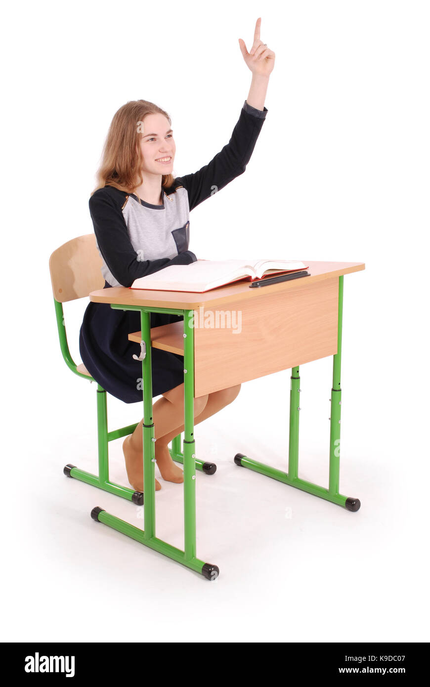 Adolescent school girl raising hand à poser question isolated on white Banque D'Images