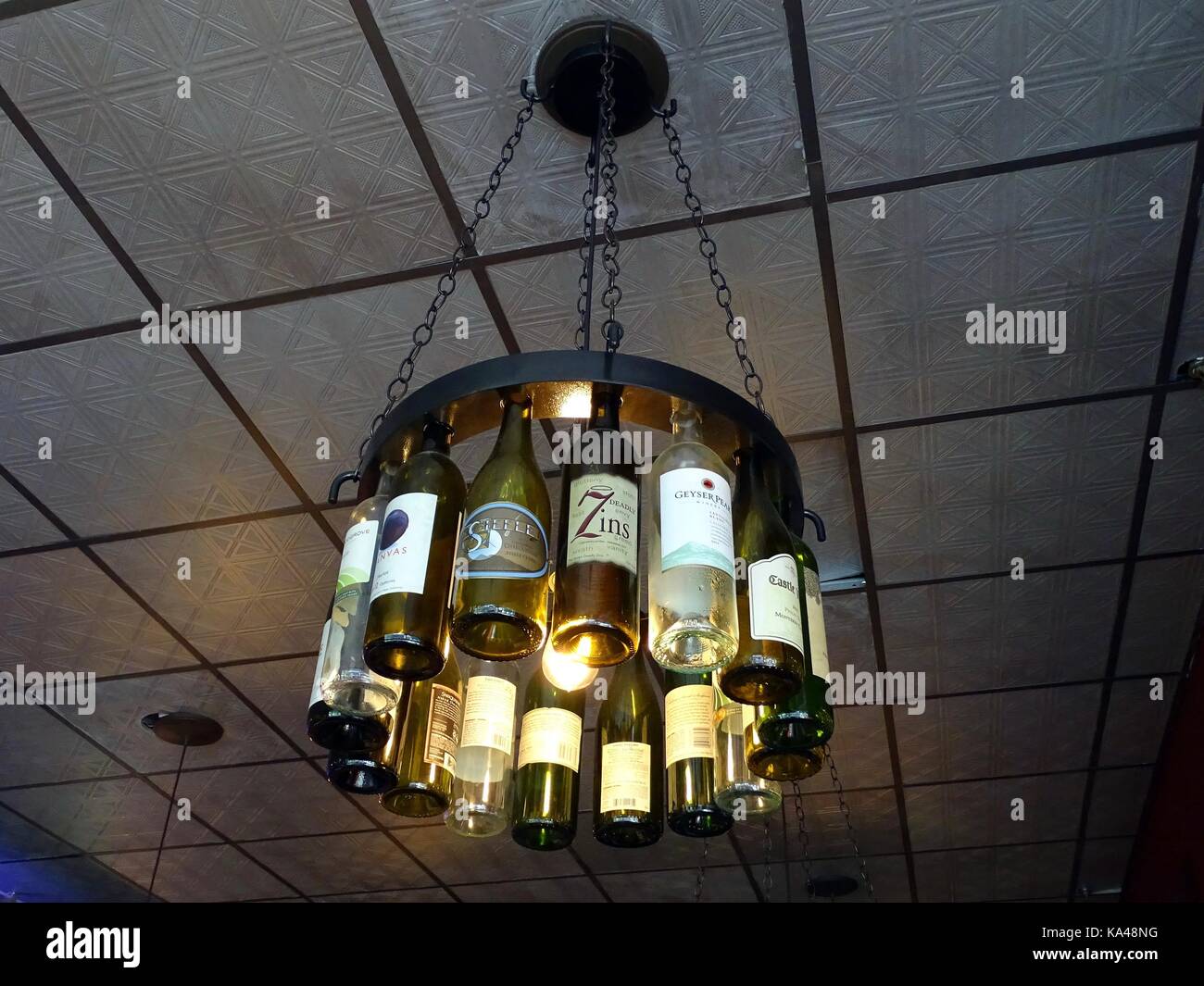 Un lustre composé utilisé des bouteilles de vin la remise d'un plafond dans la préservation d'un pub sur Market street. Banque D'Images