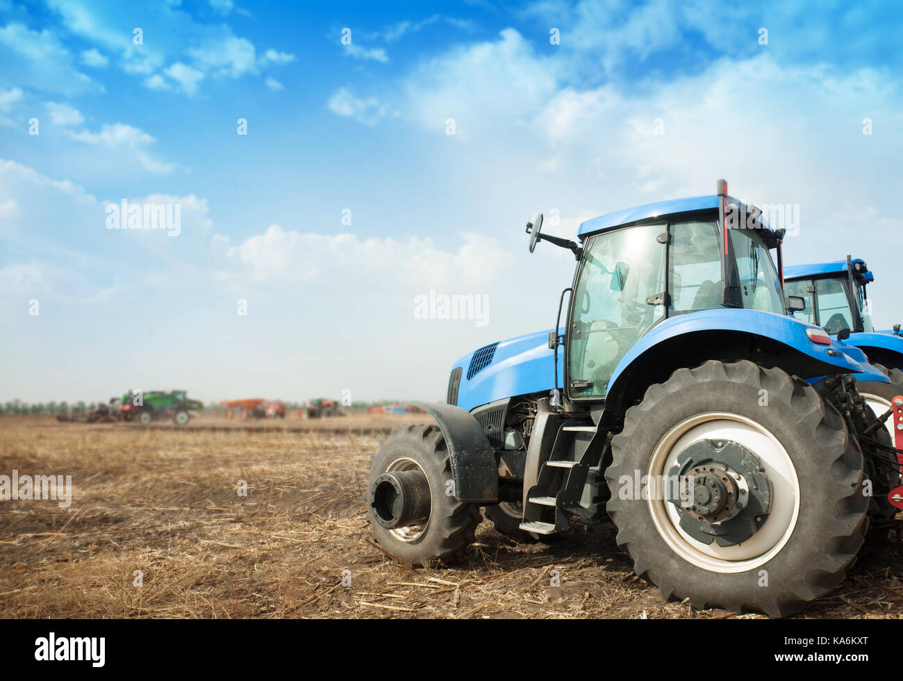 Deux tracteurs bleus dans le champ vide. machines agricoles Banque D'Images