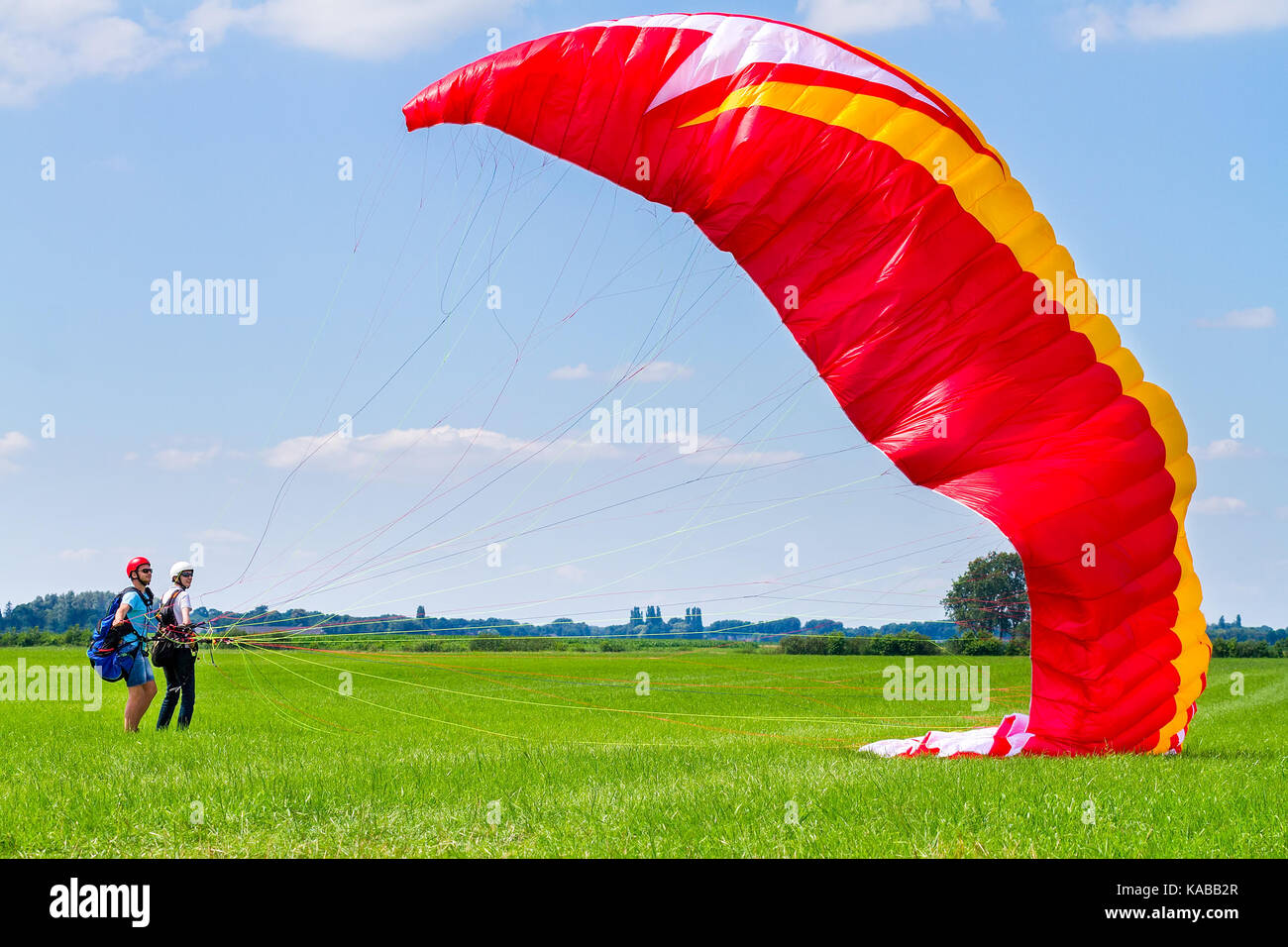 Garçon avec instructeur de parapente préparation flyer matelas Banque D'Images