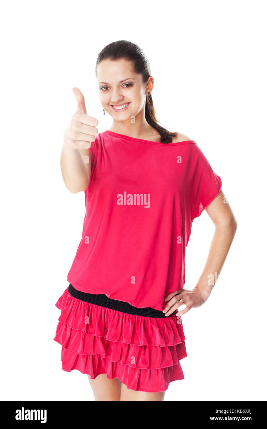 Portrait de jeune femme en robe rouge showing thumb up isolé sur fond blanc Banque D'Images