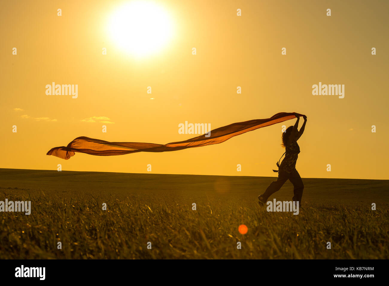 Jeune femme tournant sur un chemin rural au coucher du soleil en été. champ d'arrière-plan de la liberté sports lifestyle Banque D'Images