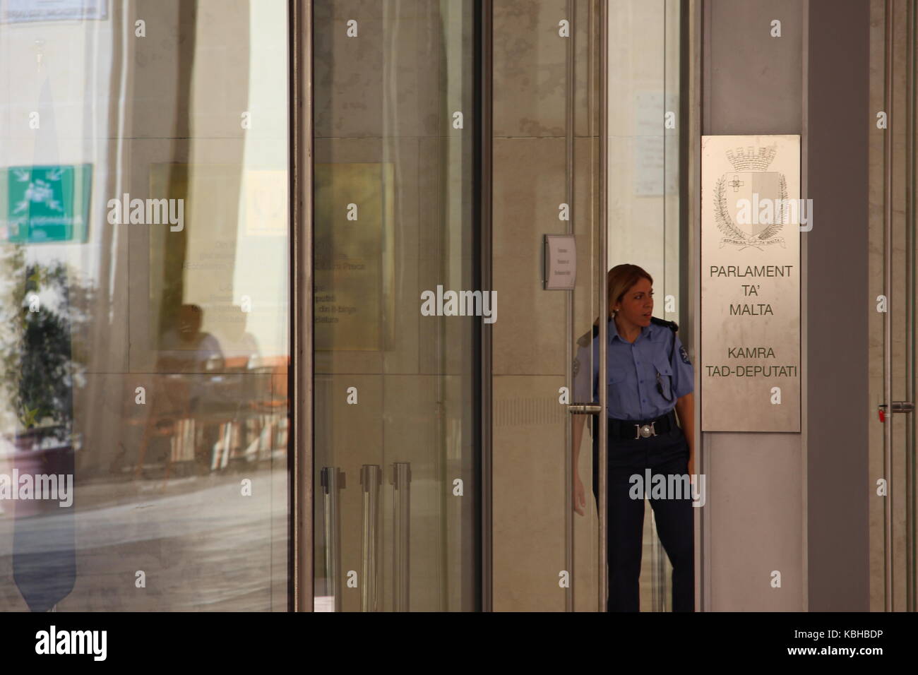 Une femme agent de police regarde par la porte du Parlement de Malte, 21 Septembre 2017 Banque D'Images