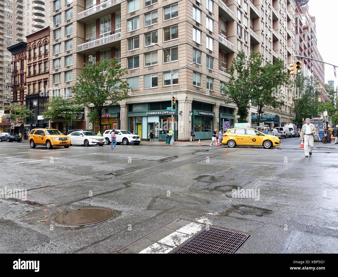 New York, NY, USA, scène de rue. Intersection 3e Ave, East 87th Street après la pluie avec les personnes qui traversent la ligne de rue, les taxis jaunes un trafic minimum. Banque D'Images