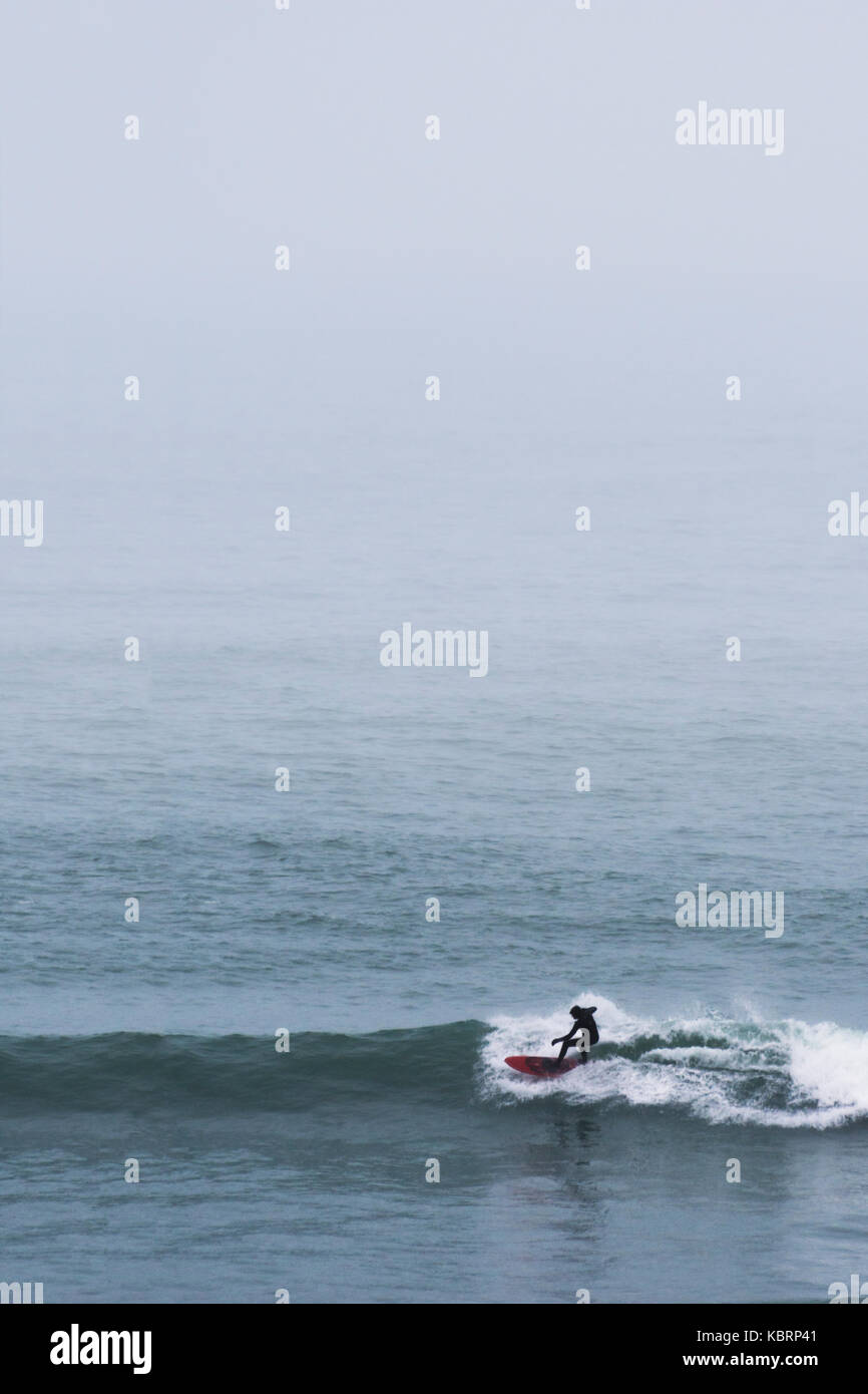 Surfer dans la brume - porthtowan, Cornwall Banque D'Images