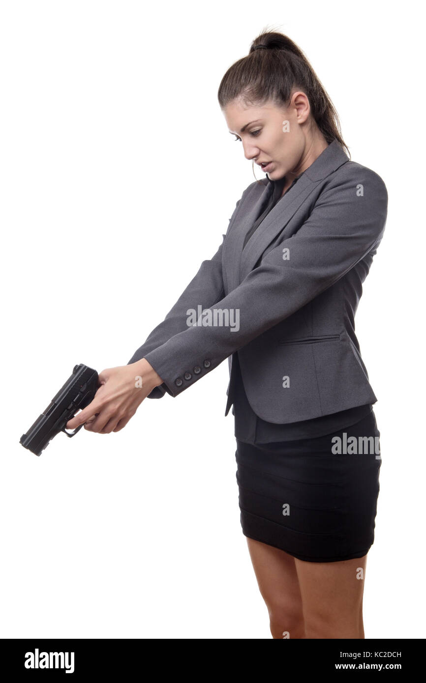 Business Woman braquer une arme sur quelque chose au sol Banque D'Images