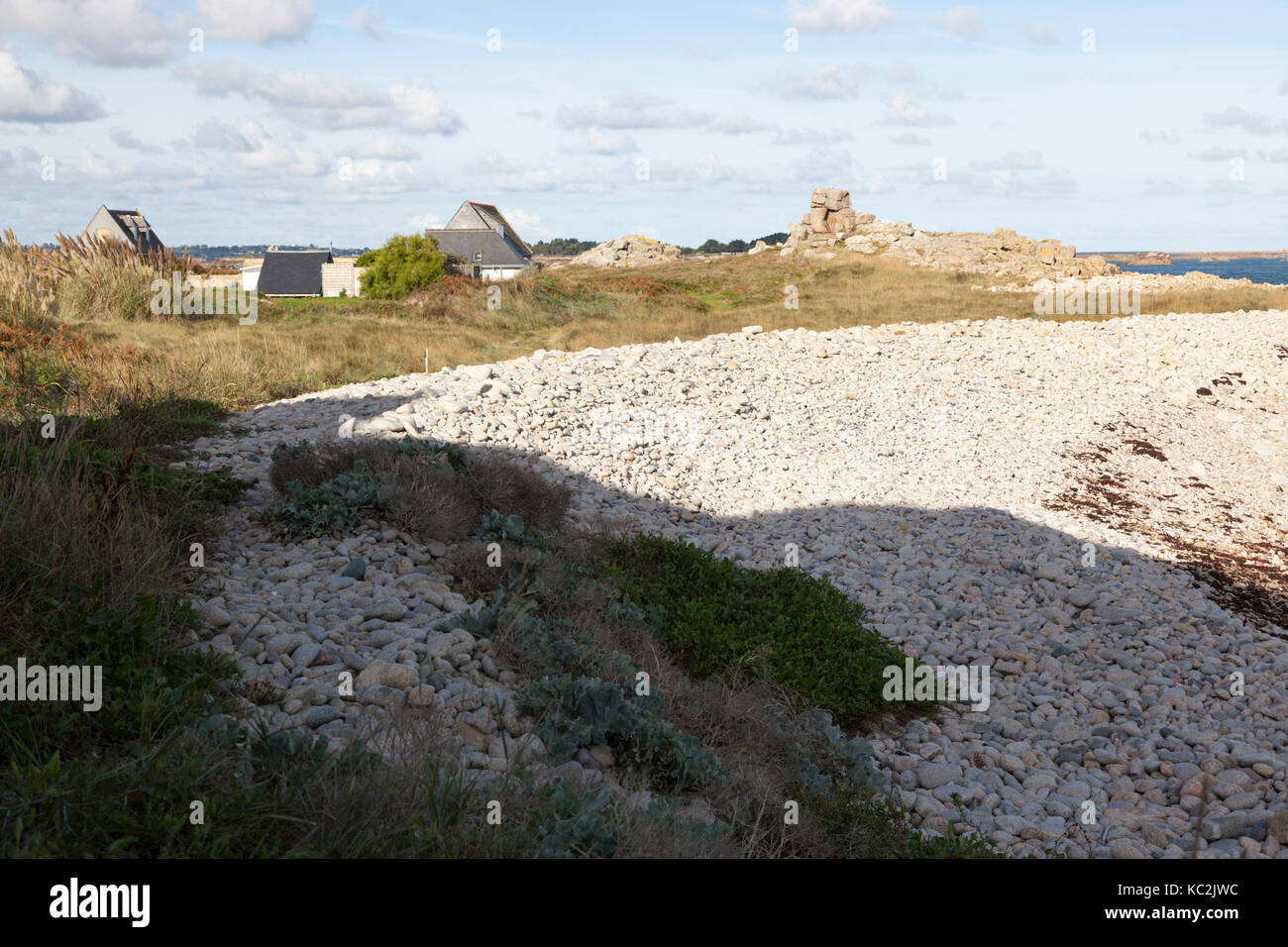 Formant un mur de deux mètres d'eau de mer, un tas de cailloux, créé par des tempêtes sur la côte nord-ouest de l'île de Bréhat (Bretagne - France). Banque D'Images