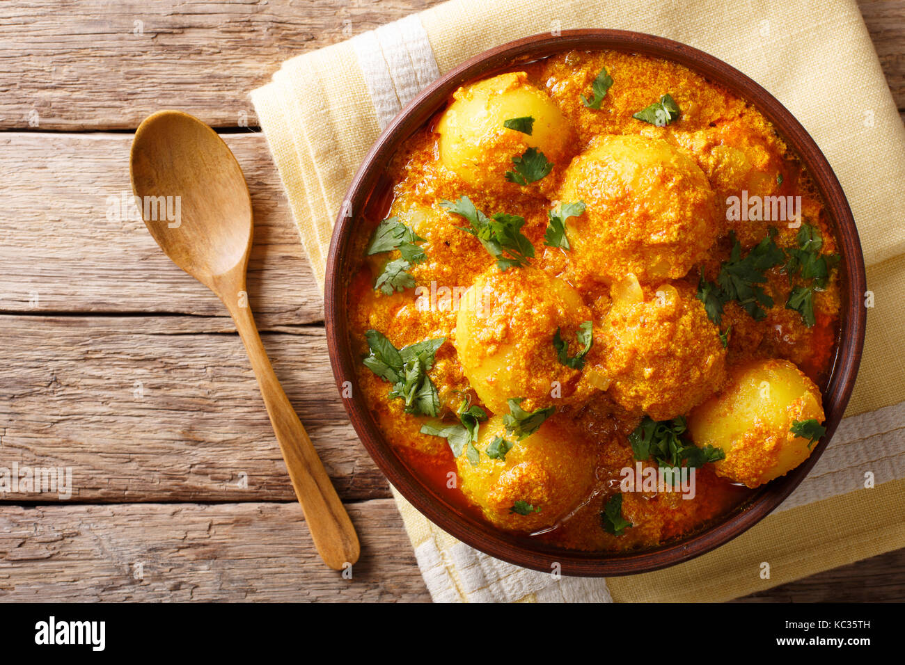 Pommes de terre frites indiennes dum aloo dans curry sauce close-up dans un bol. haut horizontale Vue de dessus Banque D'Images