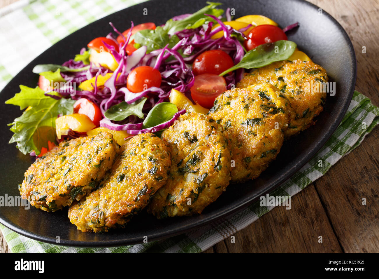 Beignets diététique du quinoa, les carottes et les épinards et salade de légumes sur une plaque horizontale. Banque D'Images