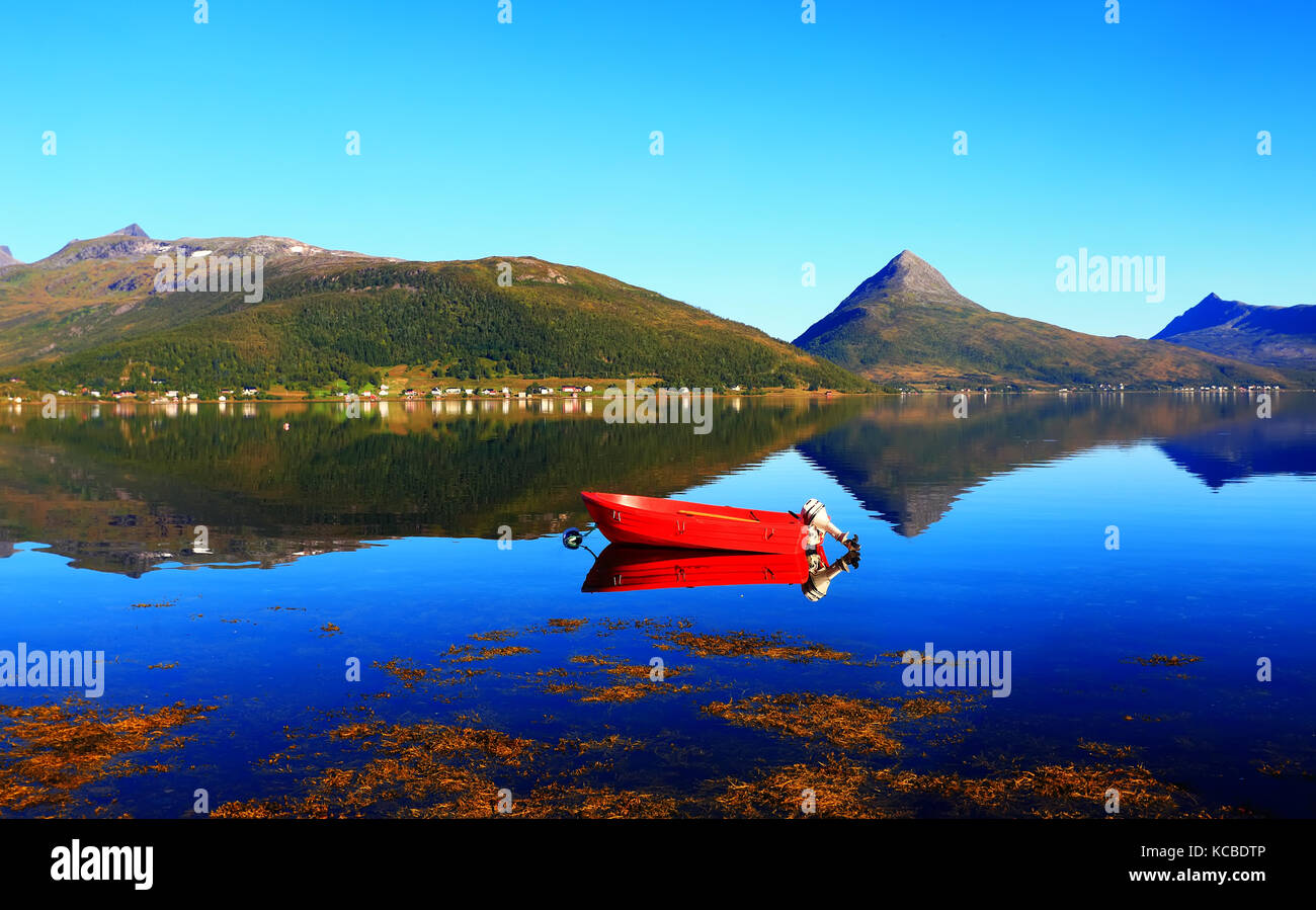 Bateau rouge sur le lac en été. lac norvégien avec voile rouge sur la journée ensoleillée. Banque D'Images