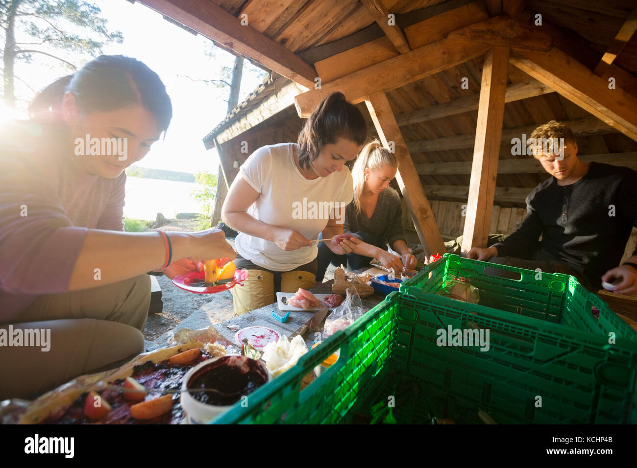 Les amis masculins et féminins multiethnique de préparer des aliments en hangar à forest Banque D'Images