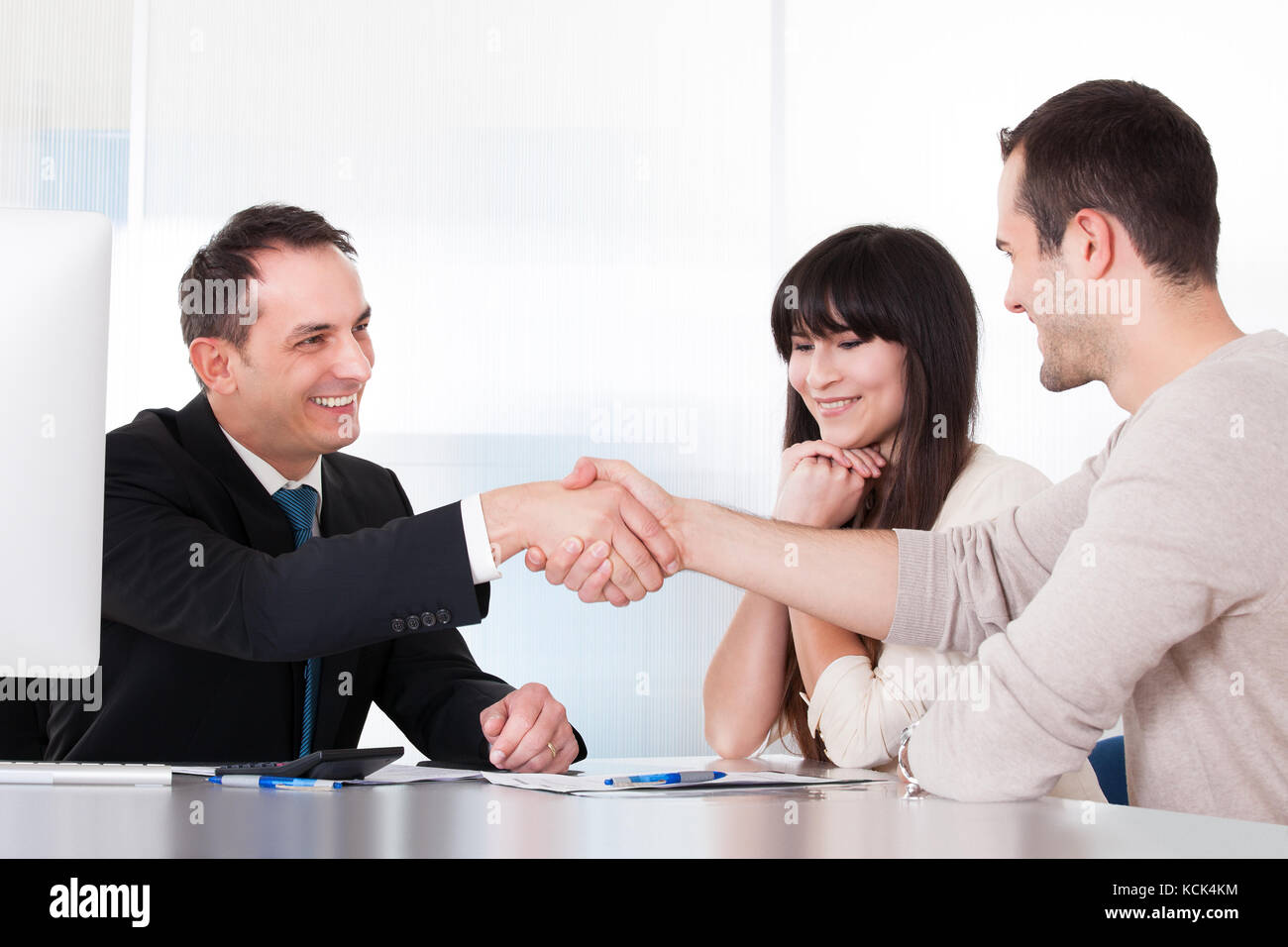 Consultant shaking hands with a man in office Banque D'Images