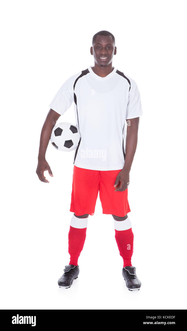 Portrait of happy african soccer player with ball over white background Banque D'Images