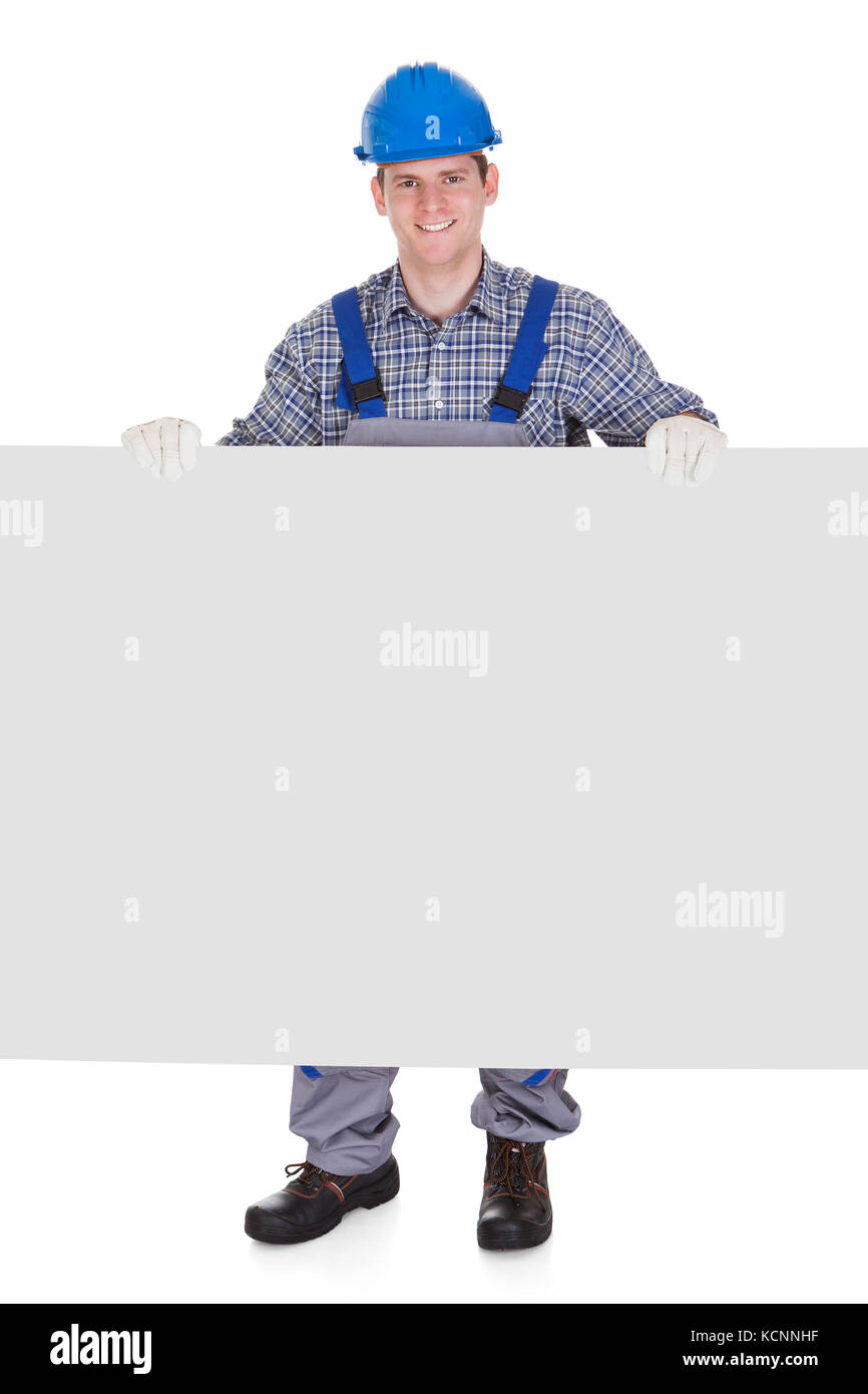 Worker wearing hardhat et holding blank placard isolé sur fond blanc Banque D'Images