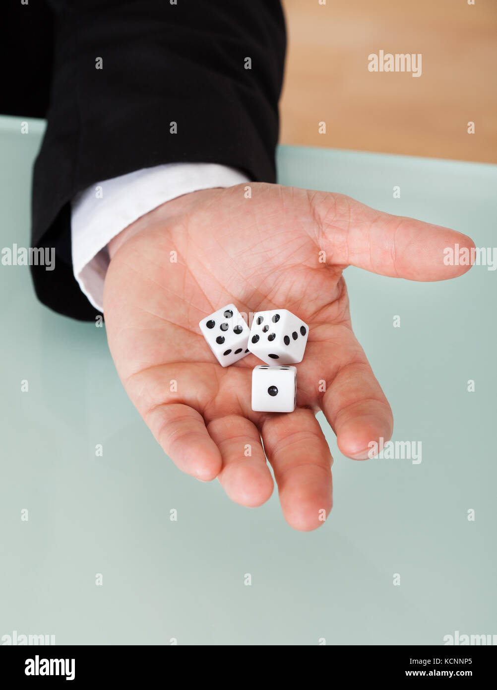 Close up of businessman in suit holding dice Banque D'Images