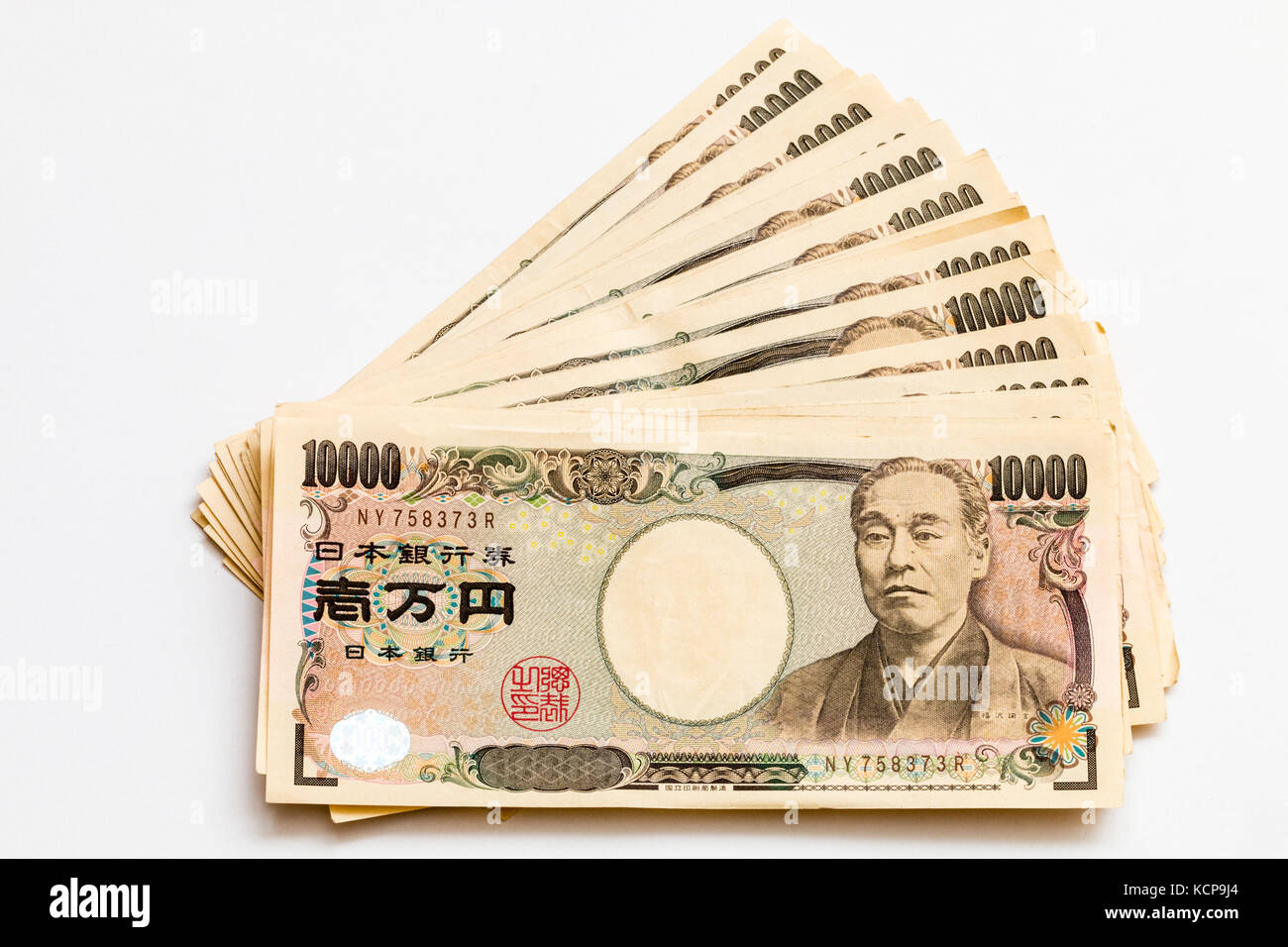 Billets en japonais. Plusieurs 10 000 yens propagation notes en palme contre fond blanc. Banque D'Images