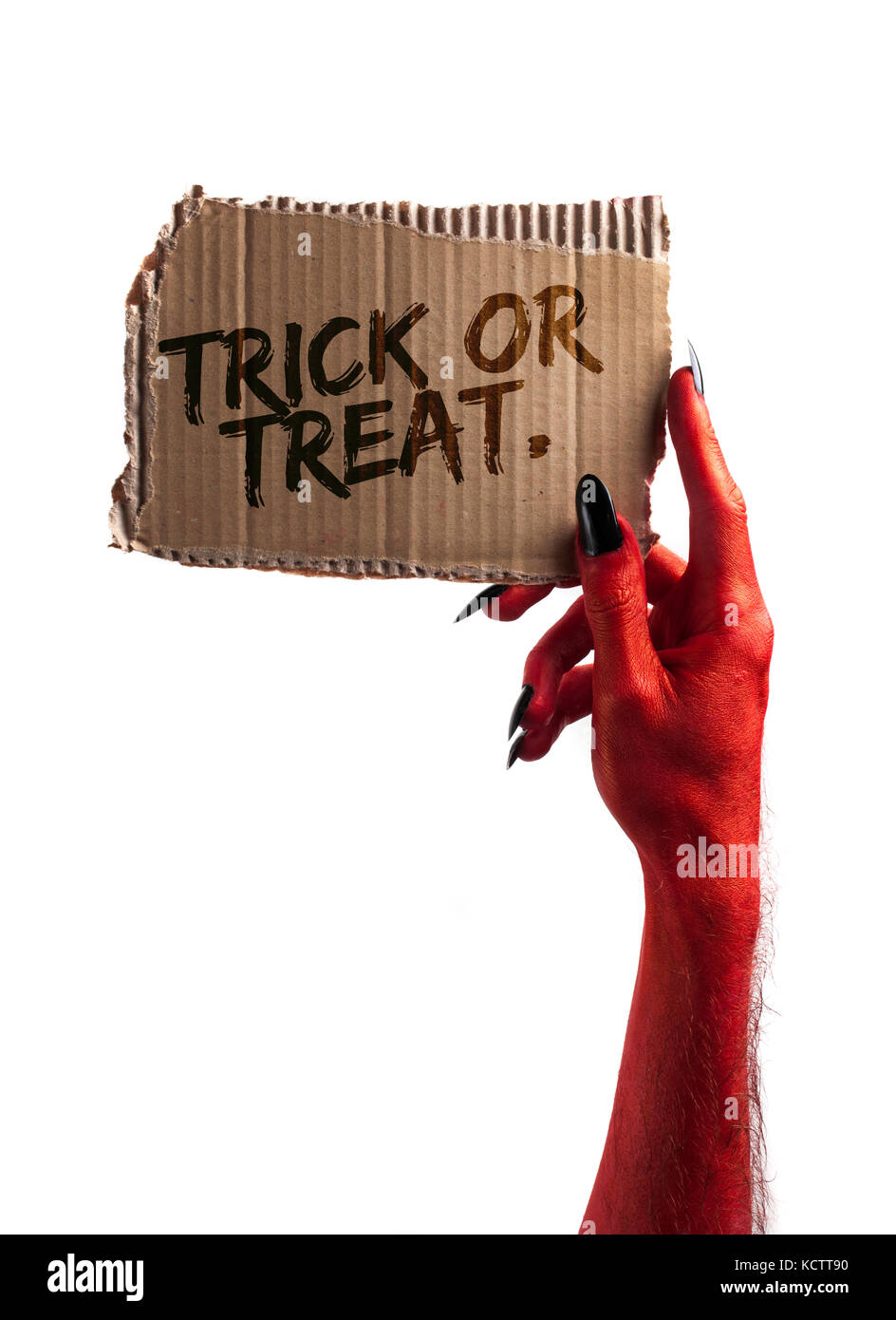 Trick or Treat. diable rouge ou zombie halloween monster hand holding a sign Banque D'Images
